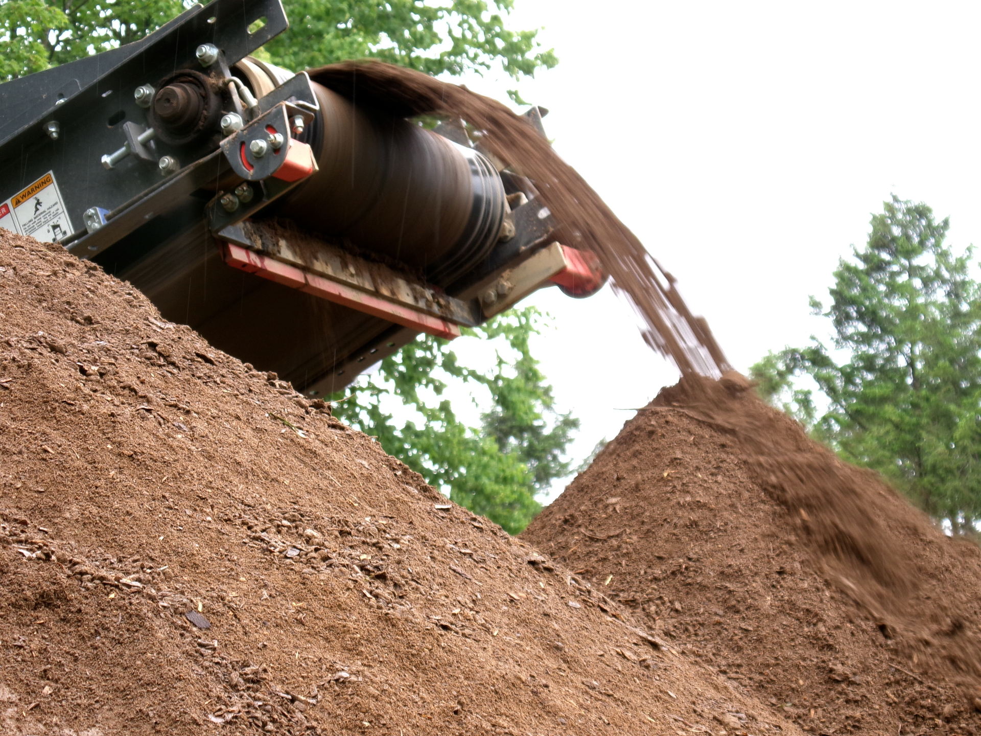 Conveyor piling organic screened topsoil
